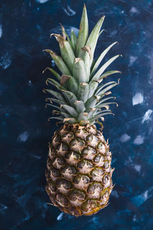 simple food ingredients concept, close-up of pineapple on dark blue backgroundの写真素材