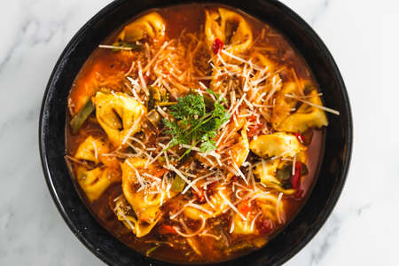 healthy plant-based food recipes concept, vegan eggplant tortellini with tomato sauce and dairy-free parmesanの写真素材