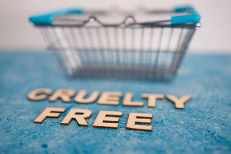 Vegan products and animal rights concept, Cruelty Free text on blue background with shopping cartの写真素材