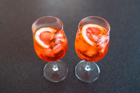 wine glasses with orange cocktails on kitchen countertop shot at shallow depth of field