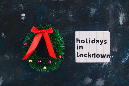 holidays in lockdown due to covid conceptual image, mini decorative Christmas tree pines with memo about lockdownの写真素材