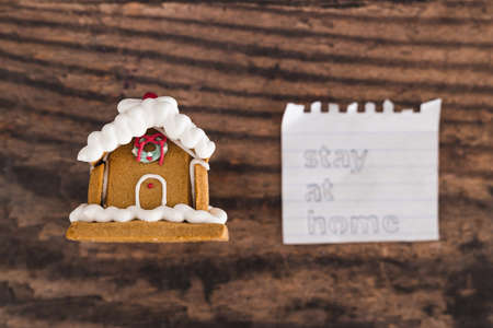 holidays in lockdown due to covid conceptual image, mini decorative Christmas gingerbread house with...