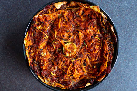 healthy plant-based food recipes concept, vegan lasagna with dairy free cheese spiralized zucchini and mushroom mince in garlic tomato sauceの写真素材