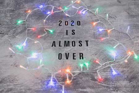fetive fairy lights with text 2020 is almost over, concept of facing the challenges caused by the...