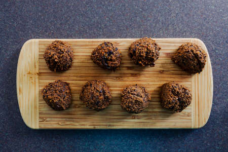 healthy plant-based food recipes concept, vegan meatballs made of black beans mushroom mince and textured vegetable protein on cutting boardの写真素材