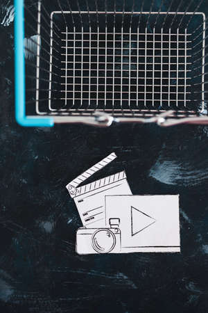 creative content sold online conceptual image, photo and video digital downloads icon in shopping basketの写真素材