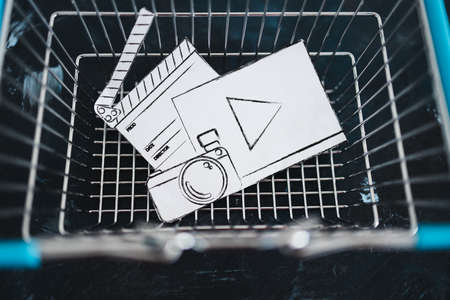 creative content sold online conceptual image, photo and video digital downloads icon in shopping basketの写真素材