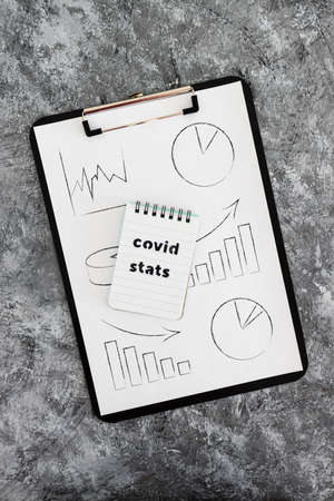 life after the covid-19 virus pandemic conceptual image, clipboard with graph and Covid Stats text