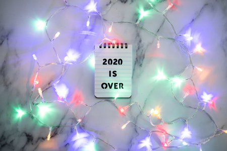 festive fairy lights with text 2020 is over, facing the challenges caused by the outbreak of the...