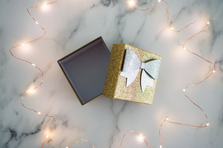 presents and special occasions conceptual image, open gift box with gold and silver glitters...