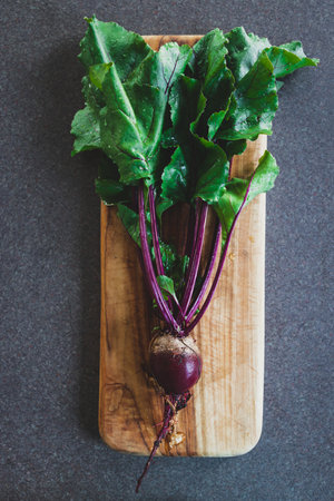 simple food ingredients concept, fresh beetroot with leaves just picked up from the garden on...