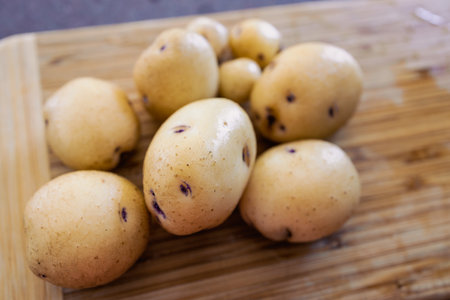 simple food ingredients concept, baby potatoes on cutting boardの写真素材