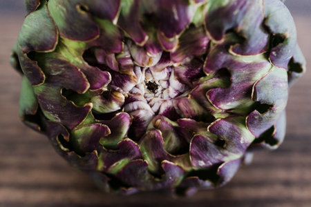 simple food ingredients concept, freshly harvested artichoke on wooden kitchen counterの写真素材