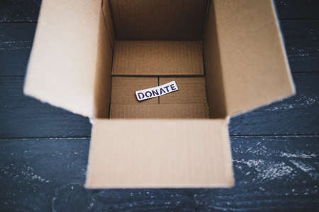 charity donation and decluttering items to be thrifted concept, empty box with Donate label ready to...