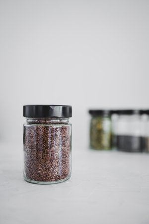 simple food ingredients concept, seed jars with sesame poppy pupmkin chia and flax seeds as important nutrient sources for nutrition shot on white backgroundの写真素材