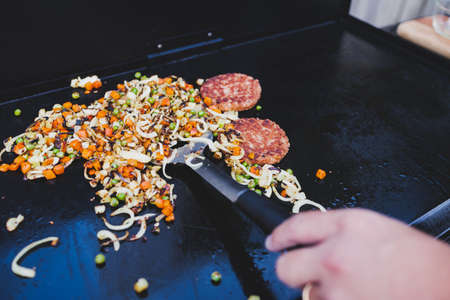 grilled diced vegetables and onion rings on the barbecue, concept of healthy plant-based foodの写真素材