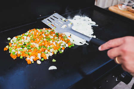 grilled diced vegetables and onion rings on the barbecue, concept of healthy plant-based foodの写真素材