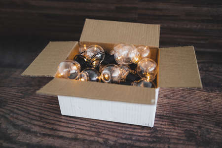 mindset and thinking outside the box concept, group of light bulbs shining from an open boxの写真素材