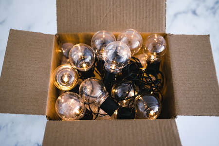 mindset and thinking outside the box concept, group of light bulbs shining from an open boxの写真素材