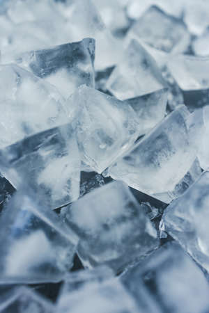 close-up of ice cubes in freezer tray with cold blue tones and contrasty tones