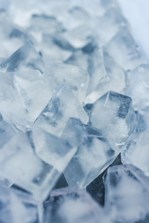 close-up of ice cubes in freezer tray with cold blue tones and contrasty tonesの写真素材