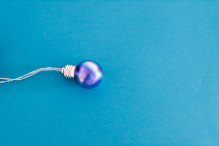 colorful blue light bulb symbol of creativity and ideas on tone on tone background with copyspace to add your text, minimalist compositionの写真素材