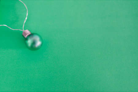 colorful green light bulb symbol of creativity and ideas on tone on tone background with copyspace to add your text, minimalist compositionの写真素材