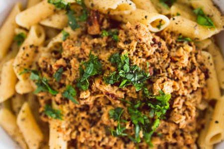 vegan penne pasta with plant-based meat and lemon sauce, healthy plant-based food recipesの写真素材