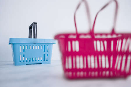 competition and retail industry conceptual image, couple of shopping baskets with different shapes and color for different brand or storesの写真素材