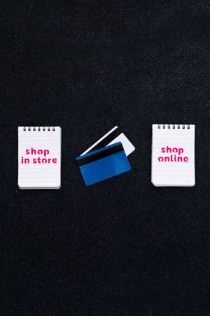 competition and retail industry conceptual image, shop in store vs shop online texts on notepads...
