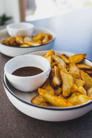 vegan mushroom gravy sauce with air fried potato wedges, healthy plant-based food recipes