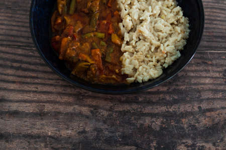 vegan stir fry with peanut sauce and coconut milk rice, healthy plant-based food recipesの写真素材