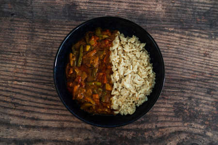 vegan stir fry with peanut sauce and coconut milk rice, healthy plant-based food recipesの写真素材