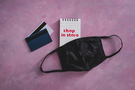 shop in store text with face mask and payment cards, competition and retail industry recovery after...