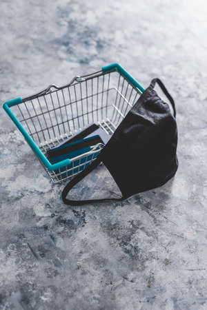shopping basket with face mask and payment cards, competition and retail industry recovery after the pandemic conceptual imageの写真素材