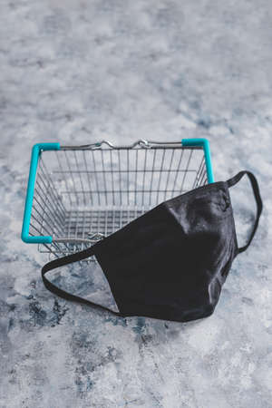 shopping basket with face mask, competition and retail industry recovery after the pandemic conceptual imageの写真素材
