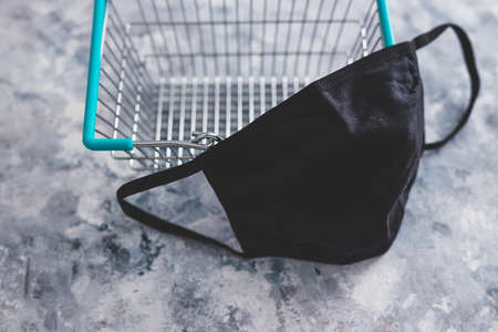 shopping basket with face mask, competition and retail industry recovery after the pandemic conceptual imageの写真素材