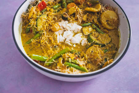 vegan yellow curry with mixed vegetables tofu and vermicelli noodles, healthy plant-based food recipesの写真素材