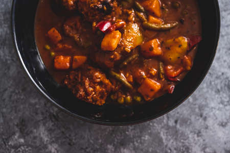 vegan vegetable stew with plant-based rissoles meatballs, healthy plant-based food recipesの写真素材