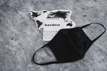 world map with face mask on it next to Borders text, concept of the travel industry after  global pandemicの写真素材