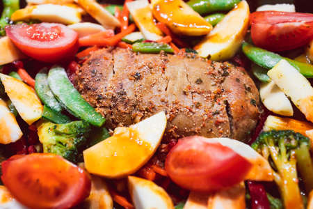 vegan roast with mixed garden vegetables and plant-based meatloaf before going in the oven, healthy...