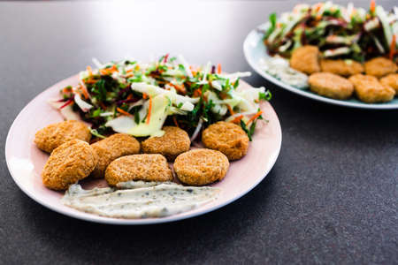 vegan nuggets with shredded salad and dairy-free sauces, healthy plant-based food recipesの写真素材