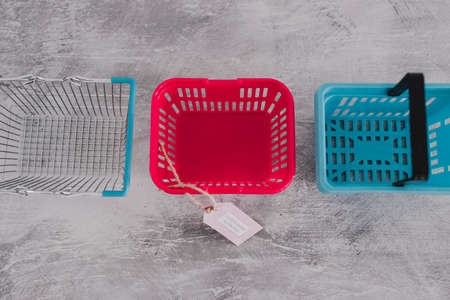 women-owned businesses tag with pink shopping basket among competitor blue ones, supporting equality and equal opportunitiesの写真素材