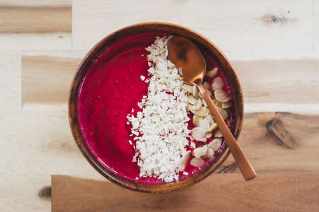 vegan smoothie bowl with raspberry vanilla oat milk smoothie topped with cocoa and coconut flakes, healthy plant-based food recipesの写真素材