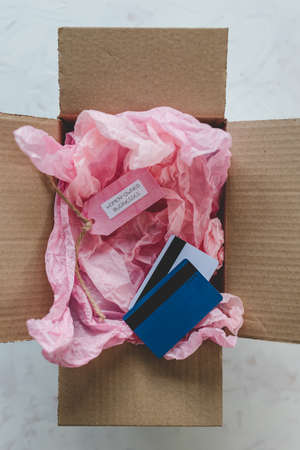 women-owned businesses tag and credit cards inside online order delivery parcel, supporting equality...