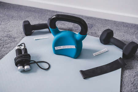 Gym time and exercising in your spare time conceptual image, kettlebell with dumbbells and skipping...