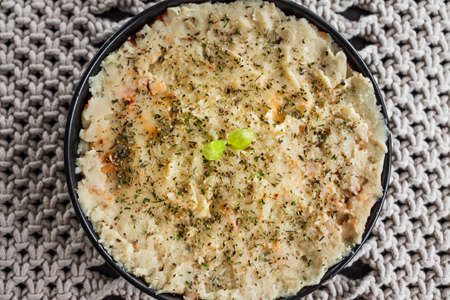 vegan lentil cottage pie with mash potato topping before going in the oven, healthy plant-based food...