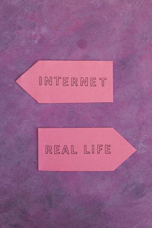 social media lifestyle concept, Internet and Real Life alternatives on signs pointing at opposite...