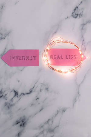 social media lifestyle concept, Internet and Real Life alternatives on signs pointing at opposite...