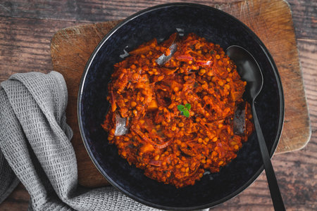 vegan eggplant lentil curry with tomato sauce and cilantro, healthy plant-based food recipesの写真素材